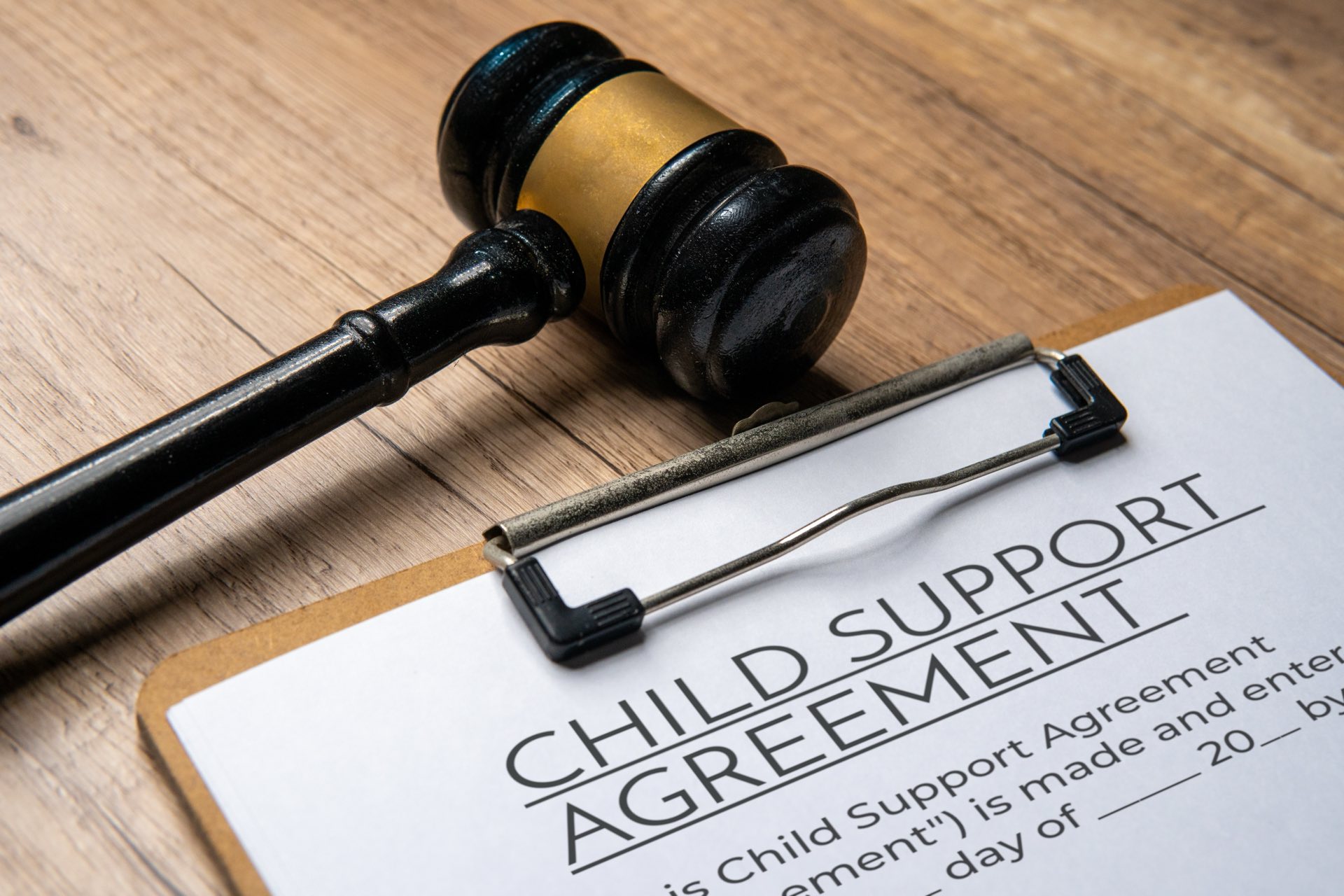 Child support agreement on a clipboard next to a gavel